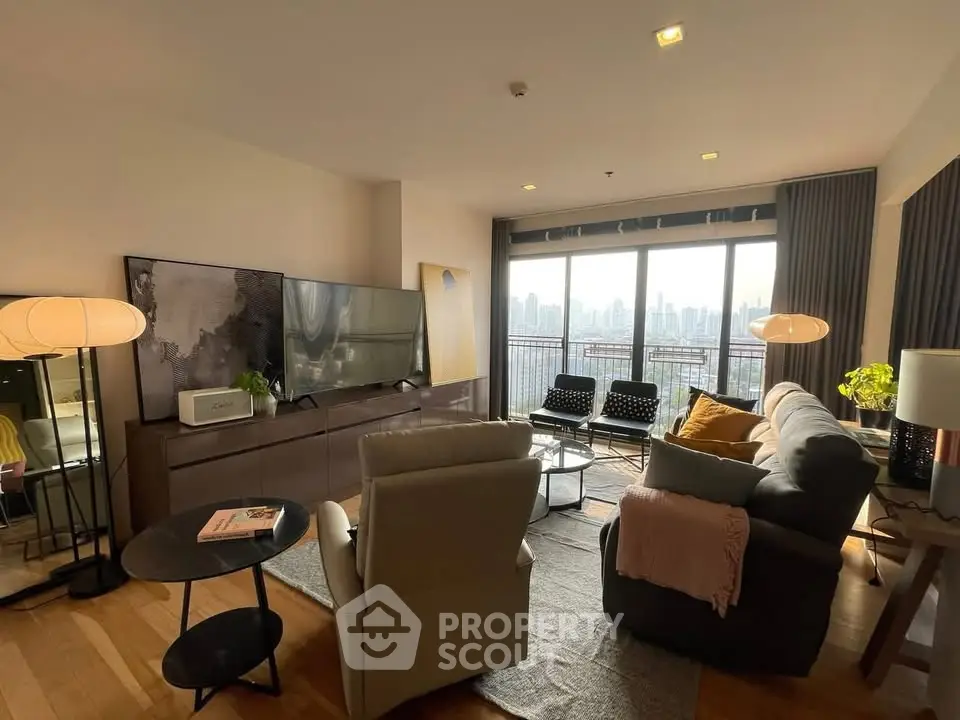 Spacious living room with modern decor and city view, featuring cozy seating and large windows.