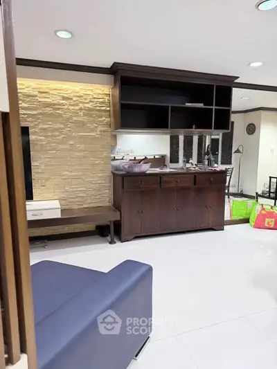 Spacious living room with modern furniture and stylish stone accent wall