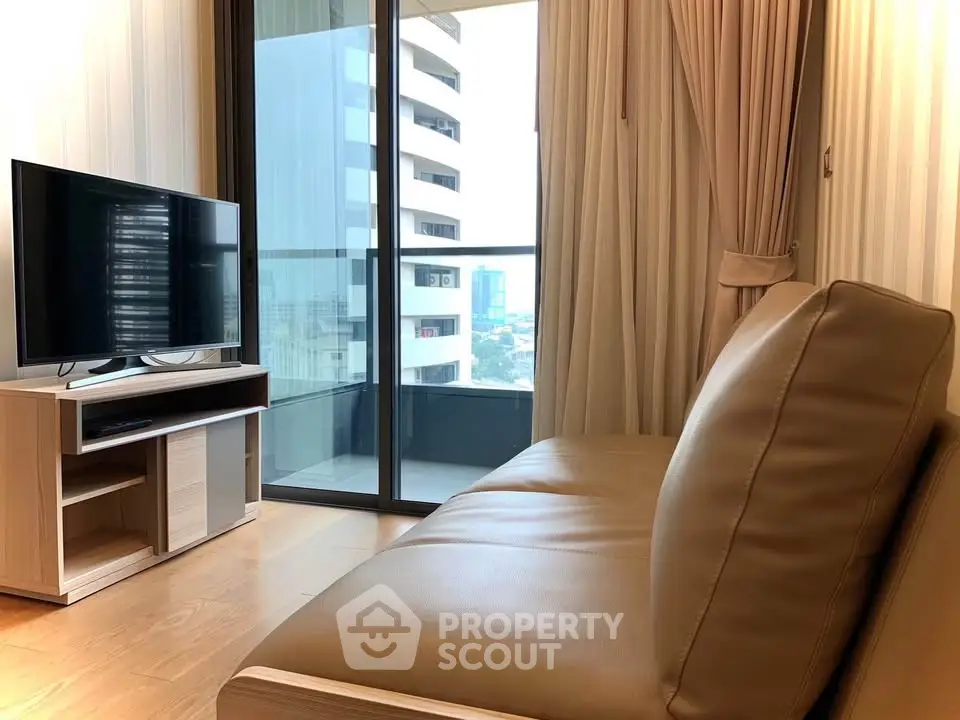 Modern living room with sleek sofa and TV, featuring a large window with city view.