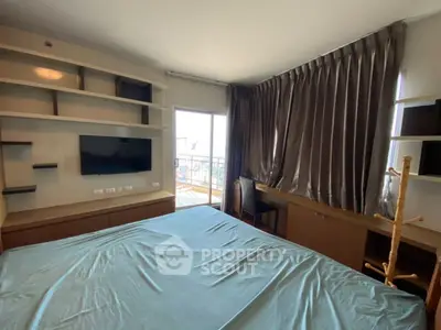 Spacious bedroom with modern furnishings and balcony access, featuring elegant curtains and built-in shelves.