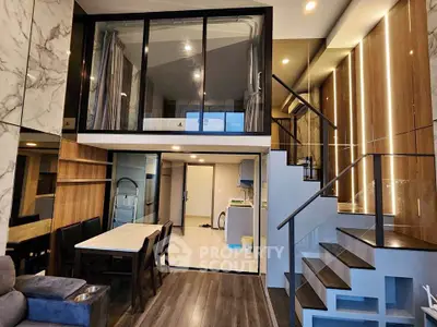 Luxurious modern duplex with elegant staircase and stylish dining area, perfect for contemporary living.