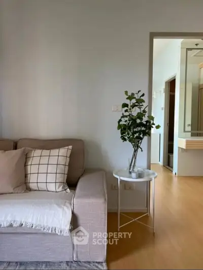 Cozy living room with modern sofa and stylish decor in a bright apartment.