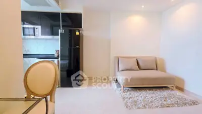 Modern living room with cozy seating and sleek kitchen appliances