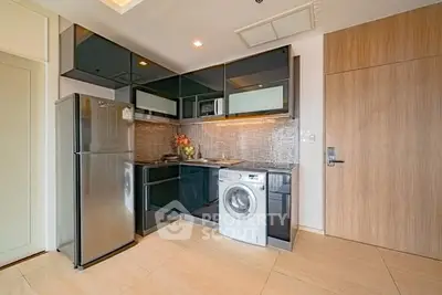 Modern kitchen with sleek appliances and stylish cabinetry in a contemporary apartment.