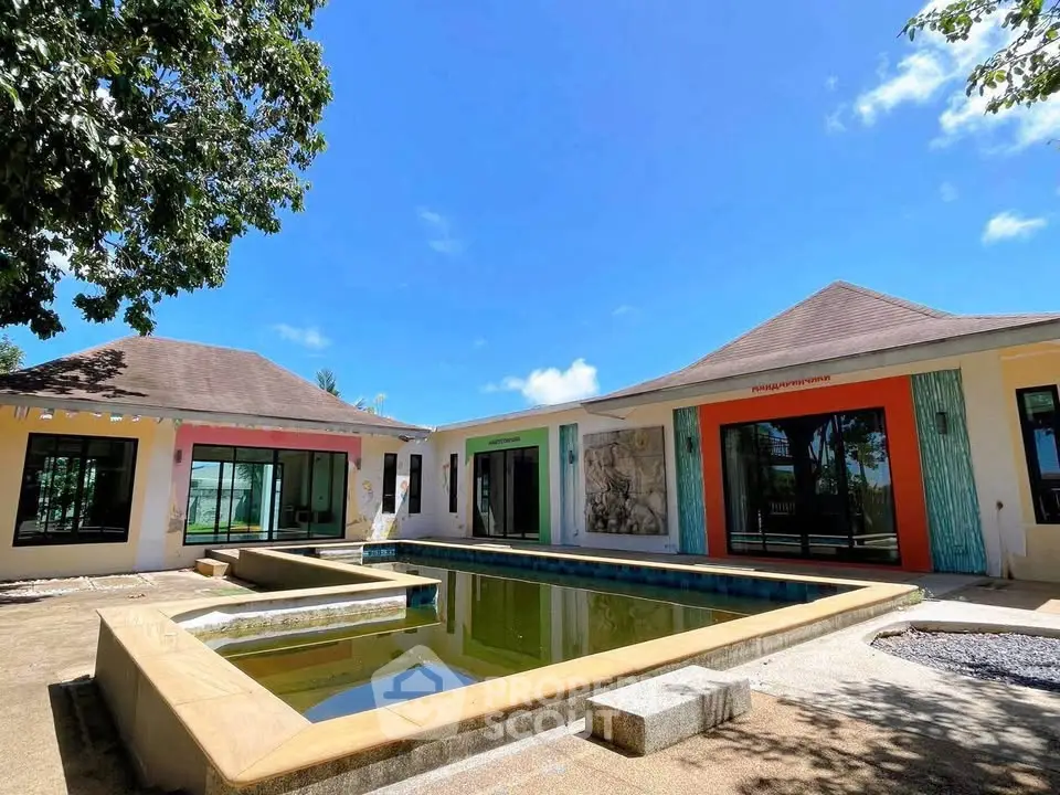Stunning modern villa with unique architecture and private pool under clear blue skies.