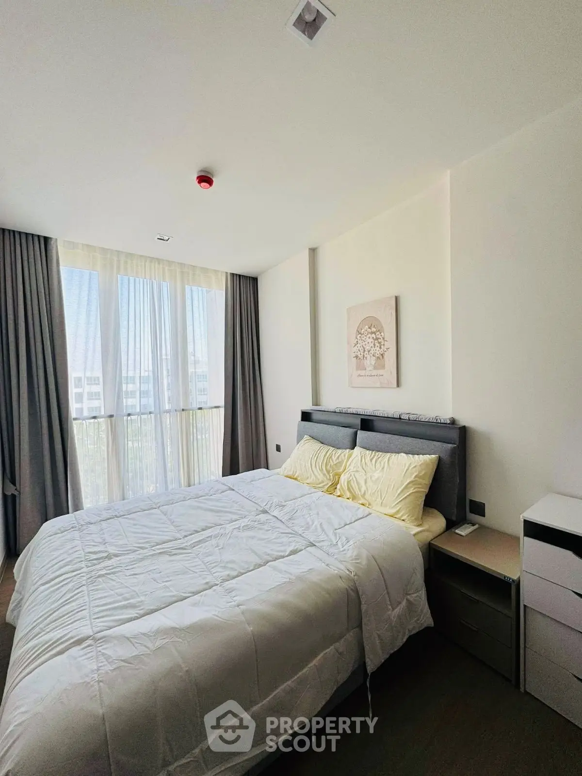 Bright and cozy bedroom with large window and modern decor