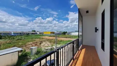 Spacious balcony with scenic view of open fields and blue sky