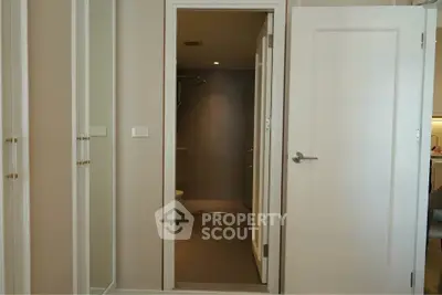 Modern bathroom entrance with sleek design and neutral tones