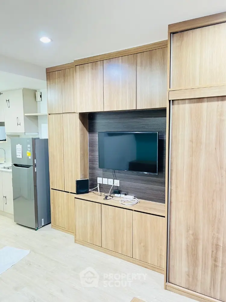 Modern living room with built-in wooden cabinets and flat-screen TV