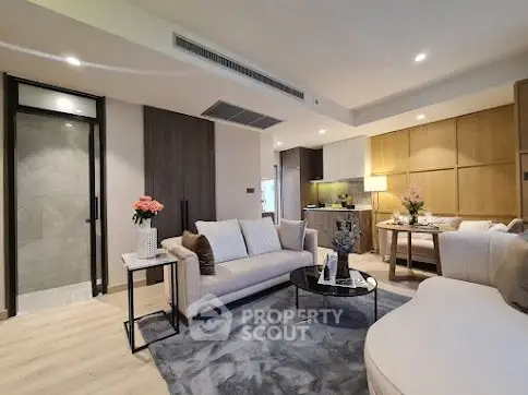 Modern living room with stylish furniture and open kitchen layout