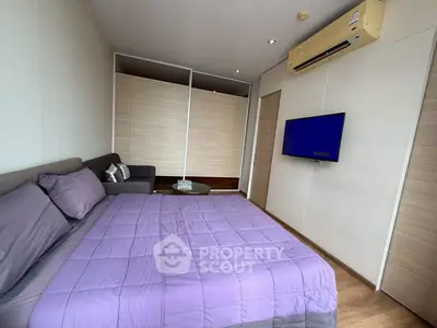 Modern bedroom with air conditioning and wall-mounted TV