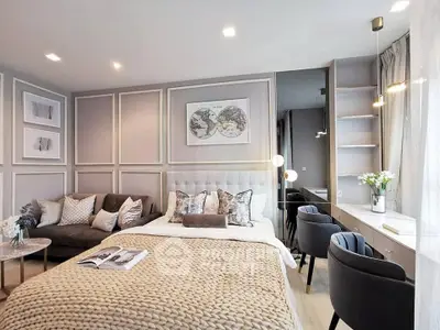 Luxurious bedroom with elegant decor, cozy seating area, and ample natural light.