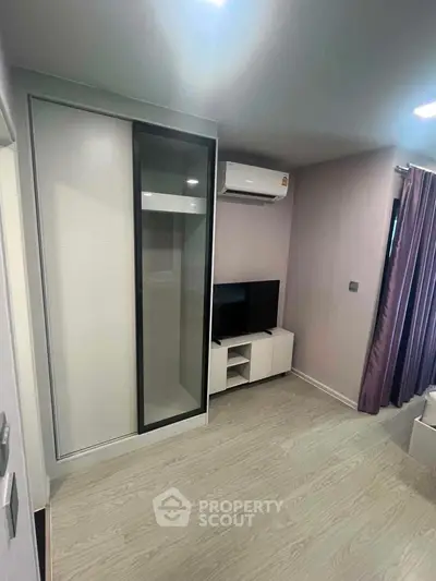 Modern living room with sleek design, featuring air conditioning and stylish furniture for a comfortable lifestyle.