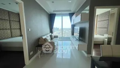 Modern apartment living room with city view, featuring sleek furniture and large windows.
