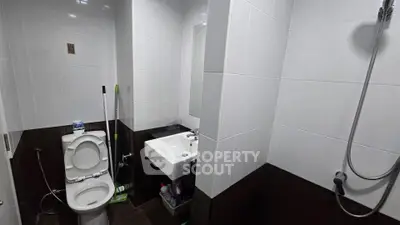 Compact bathroom with modern fixtures and shower in a real estate property.