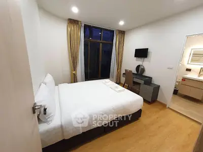 Modern bedroom with ensuite bathroom and stylish furnishings