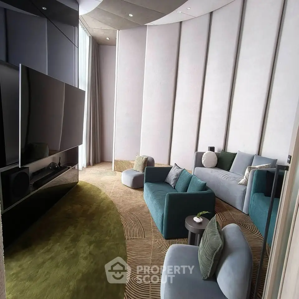 Luxurious modern living room with plush seating and large TV, perfect for relaxation and entertainment.