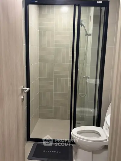 Modern bathroom with sleek shower enclosure and contemporary design.