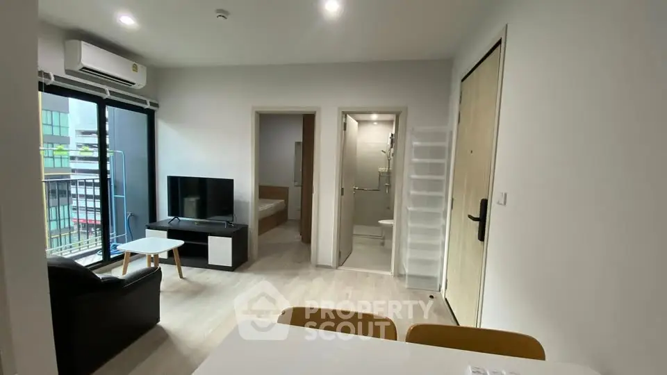 Modern apartment interior with living room, bedroom, and bathroom view.