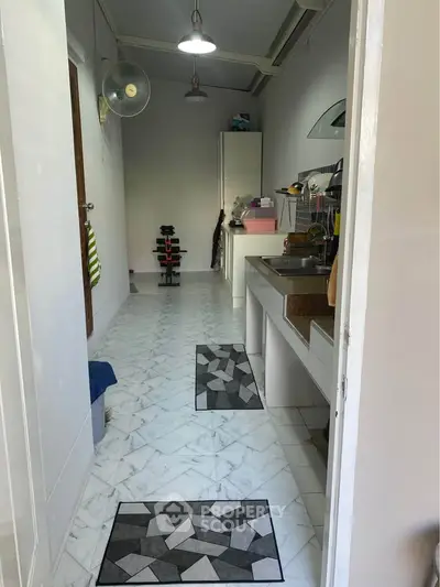 Compact kitchen with modern appliances and sleek design, featuring a functional layout and stylish flooring.