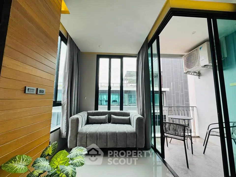 Modern living room with balcony access and stylish furniture in a contemporary apartment.