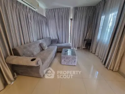 Luxurious living room with plush gray sofa and elegant curtains