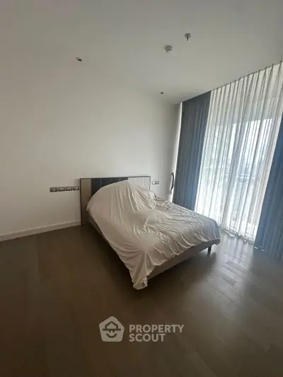 Spacious bedroom with floor-to-ceiling windows and modern design