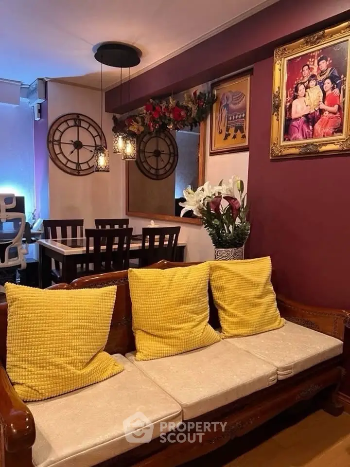 Charming living room with cozy seating, vibrant decor, and elegant wall art, perfect for relaxation and entertaining.