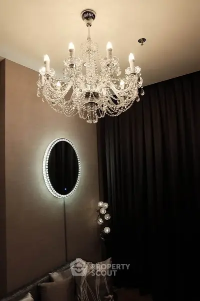 Elegant living room with crystal chandelier and modern decor