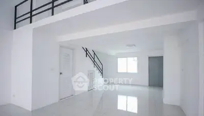 Spacious modern living room with sleek white interior and loft design