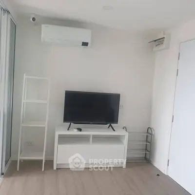 Modern living room with sleek TV setup and air conditioning unit