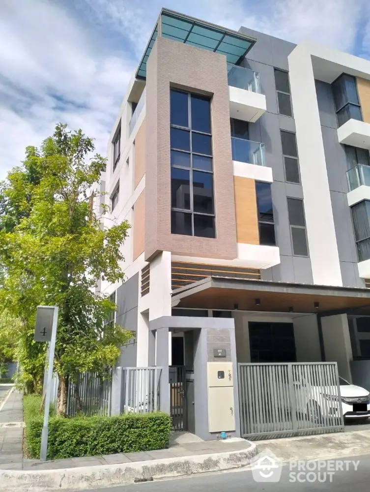 Modern multi-story residential building with sleek design and large windows