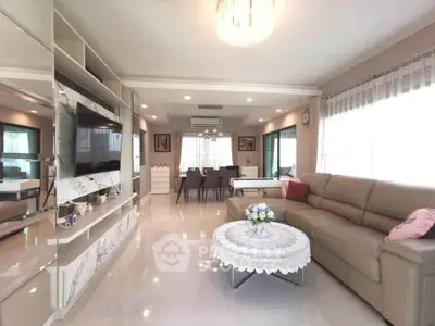 Spacious modern living room with elegant decor and ample natural light, perfect for family gatherings.