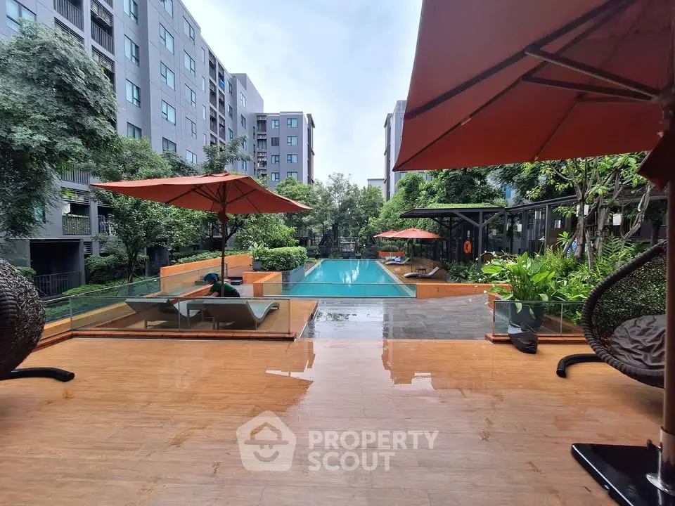 Luxurious apartment complex with pool and lush greenery, perfect for relaxation and leisure.