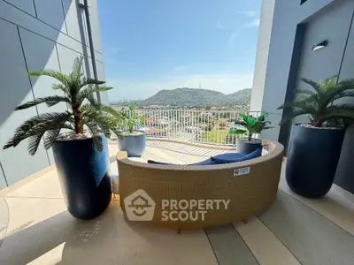 Stunning balcony with panoramic mountain views and stylish outdoor seating, perfect for relaxation.