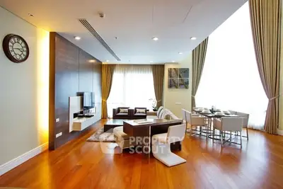 Spacious modern living room with elegant dining area and wooden flooring.