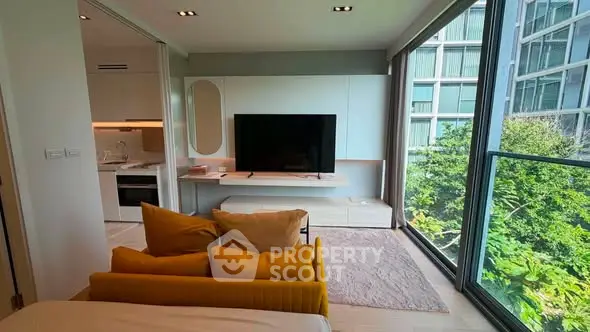 Modern living room with large windows and stylish decor in a high-rise apartment.
