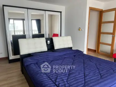 Spacious bedroom with modern furnishings and city view