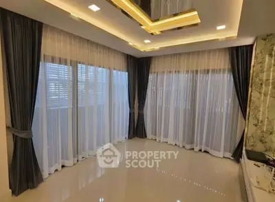 Spacious modern living room with elegant lighting and large windows