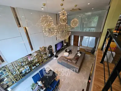 Luxurious modern living room with high ceiling and elegant chandelier