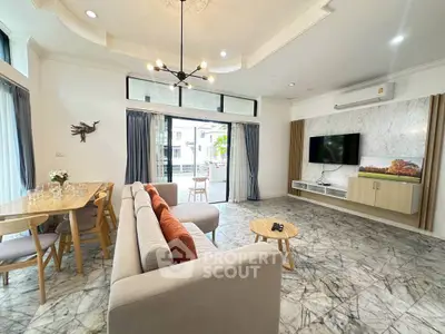 Spacious modern living room with elegant decor and large windows for natural light.