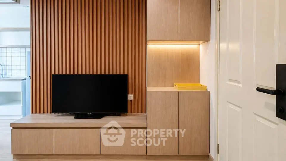 Modern living room with sleek wooden paneling and built-in TV unit