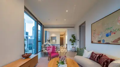 Luxurious modern living room with city view, stylish furniture, and open kitchen layout.