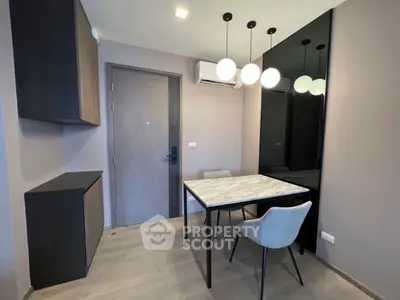 Modern study room with sleek table and chairs, featuring elegant lighting and minimalist design.