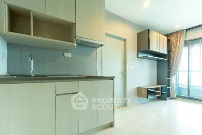 Modern kitchen with open layout and sleek cabinetry in a bright apartment.