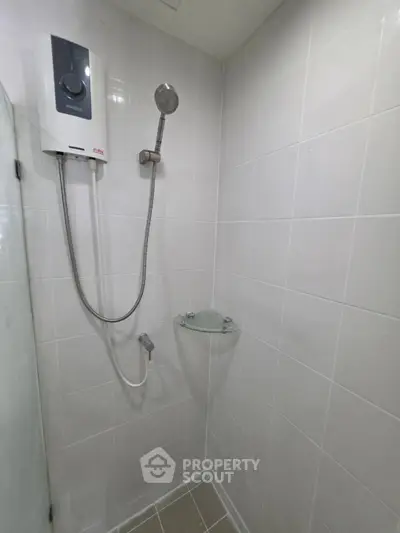 Modern bathroom with sleek shower unit and white tiled walls