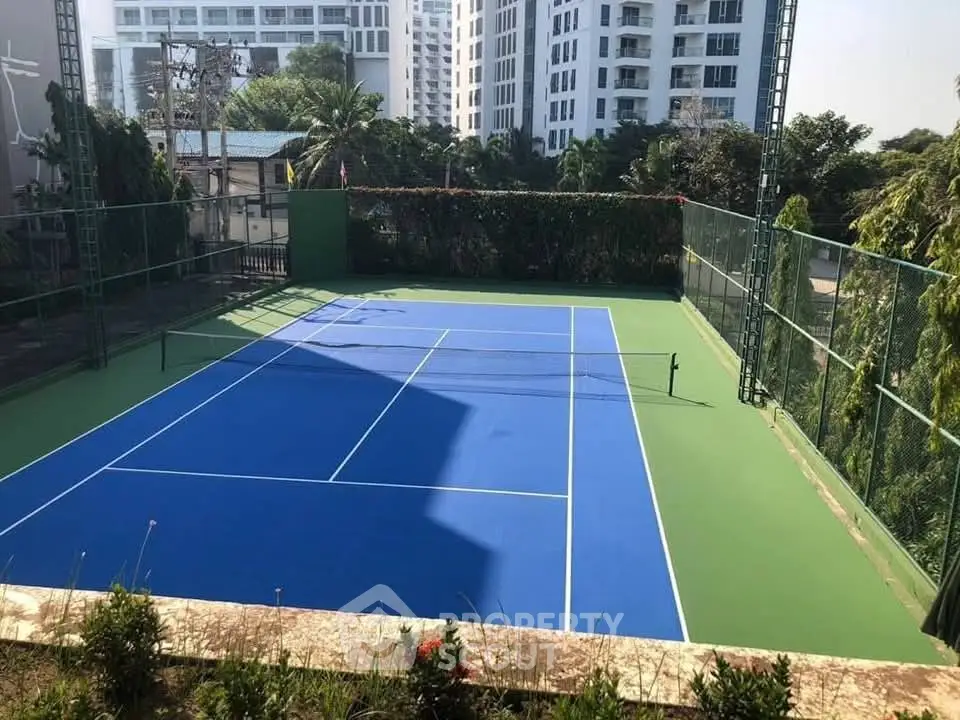 Spacious outdoor tennis court in a modern residential complex
