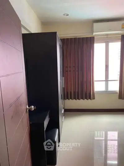 Cozy bedroom with air conditioning and ample natural light