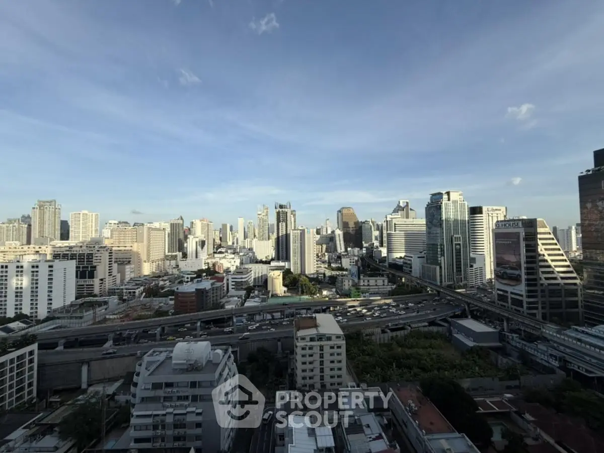 Stunning cityscape view showcasing a vibrant urban skyline with modern skyscrapers under a clear blue sky.