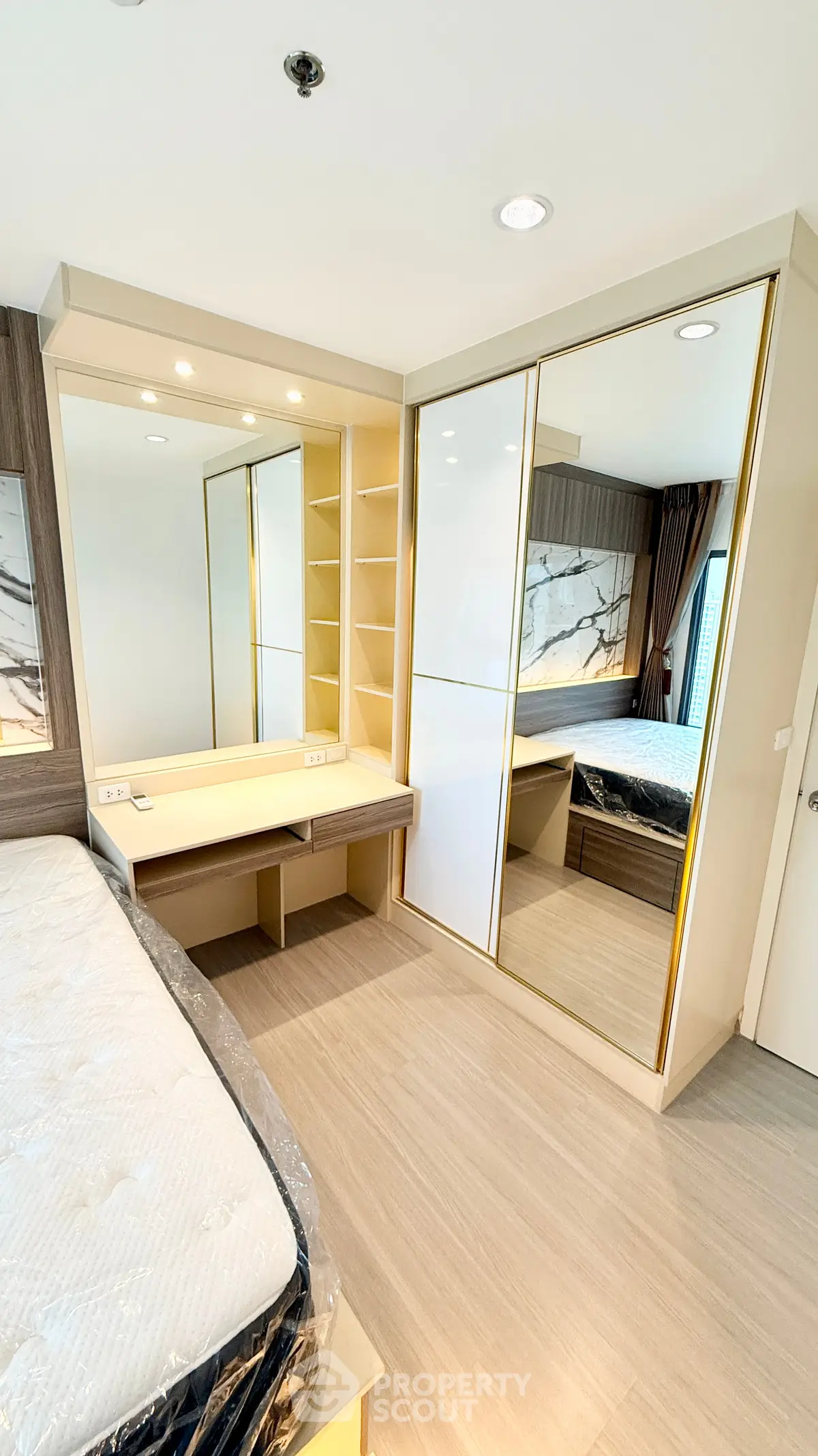 Modern bedroom with mirrored wardrobe and elegant decor